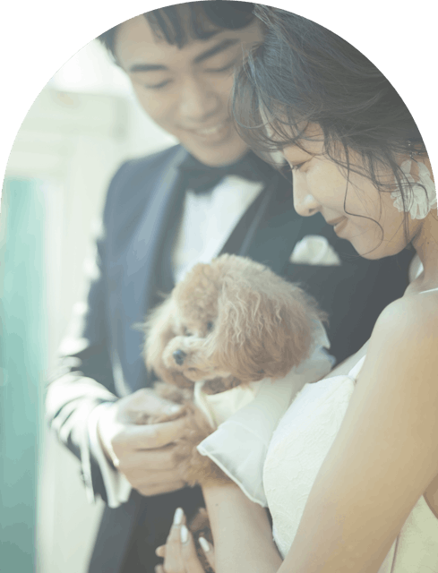 愛犬を抱っこする新郎新婦